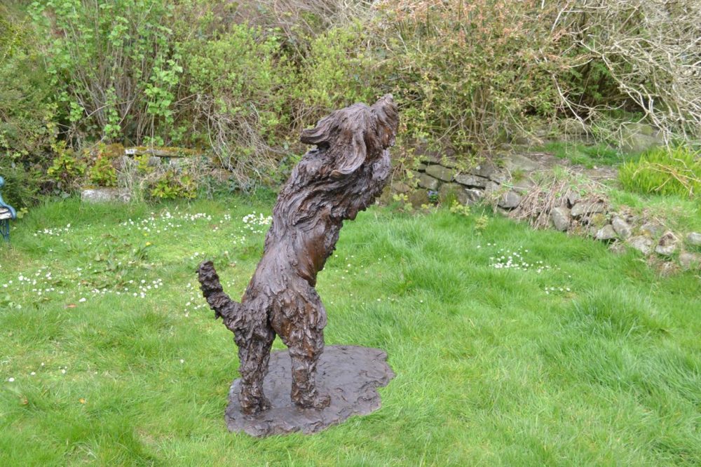 bronze leaping bearded collie statue