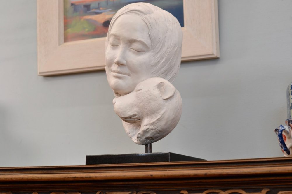 Portrait of a Dog Resting its Head on a Woman Statue