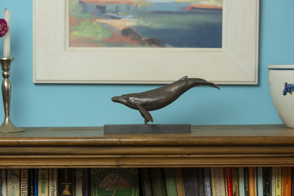 small bronze whale sculpture