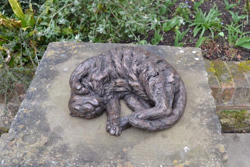 curled cat sculpture