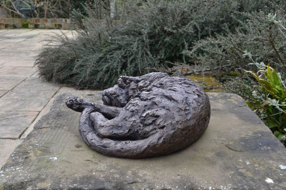bronze curled cat statue