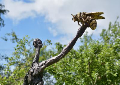 bronze woman and bee sculpture