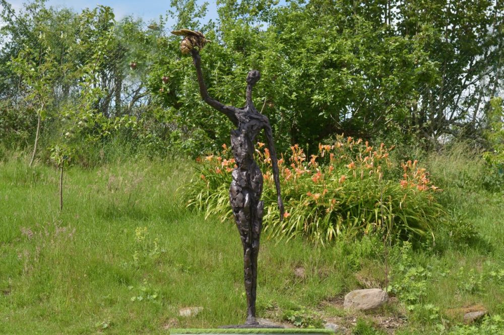 bronze woman and bee statue