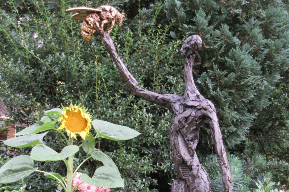 woman and bee bronze sculpture