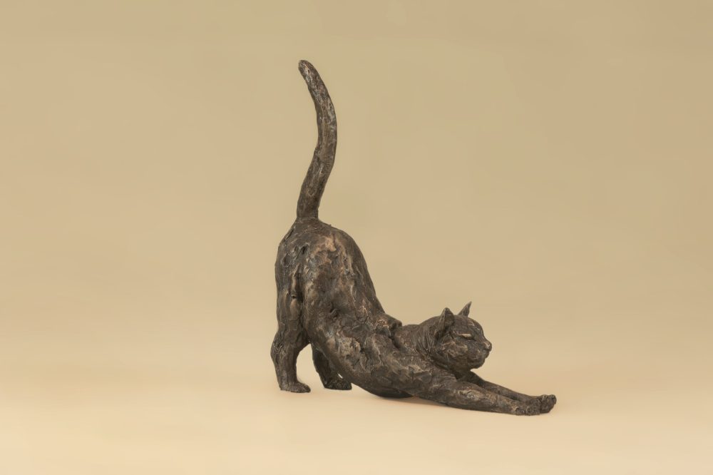 small stretching cat sculpture