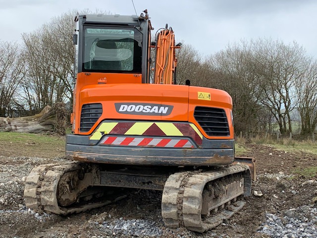 excavator digger for securing a statue