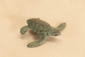 Bronze crawling baby turtle