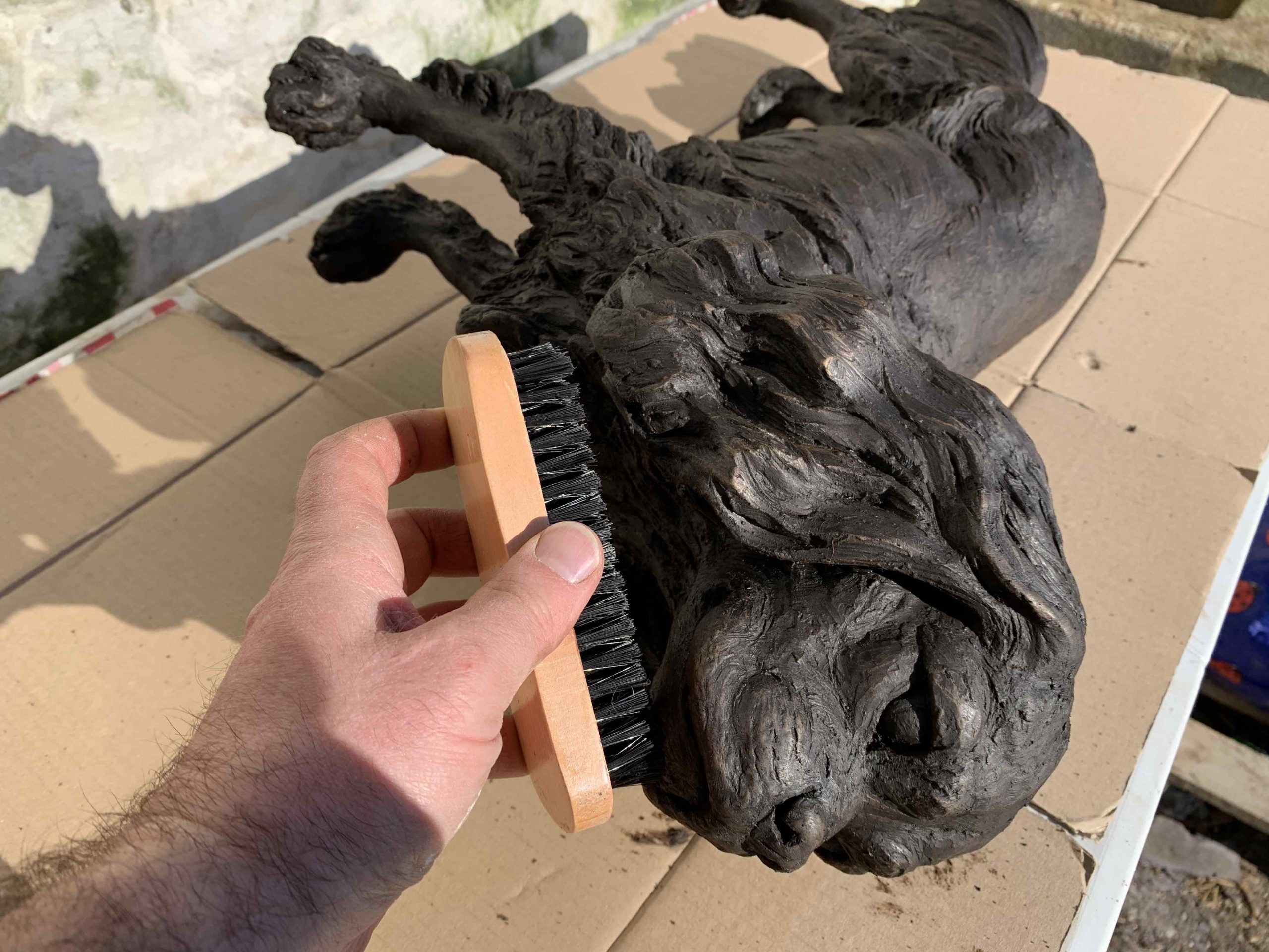 buffing a bronze statue